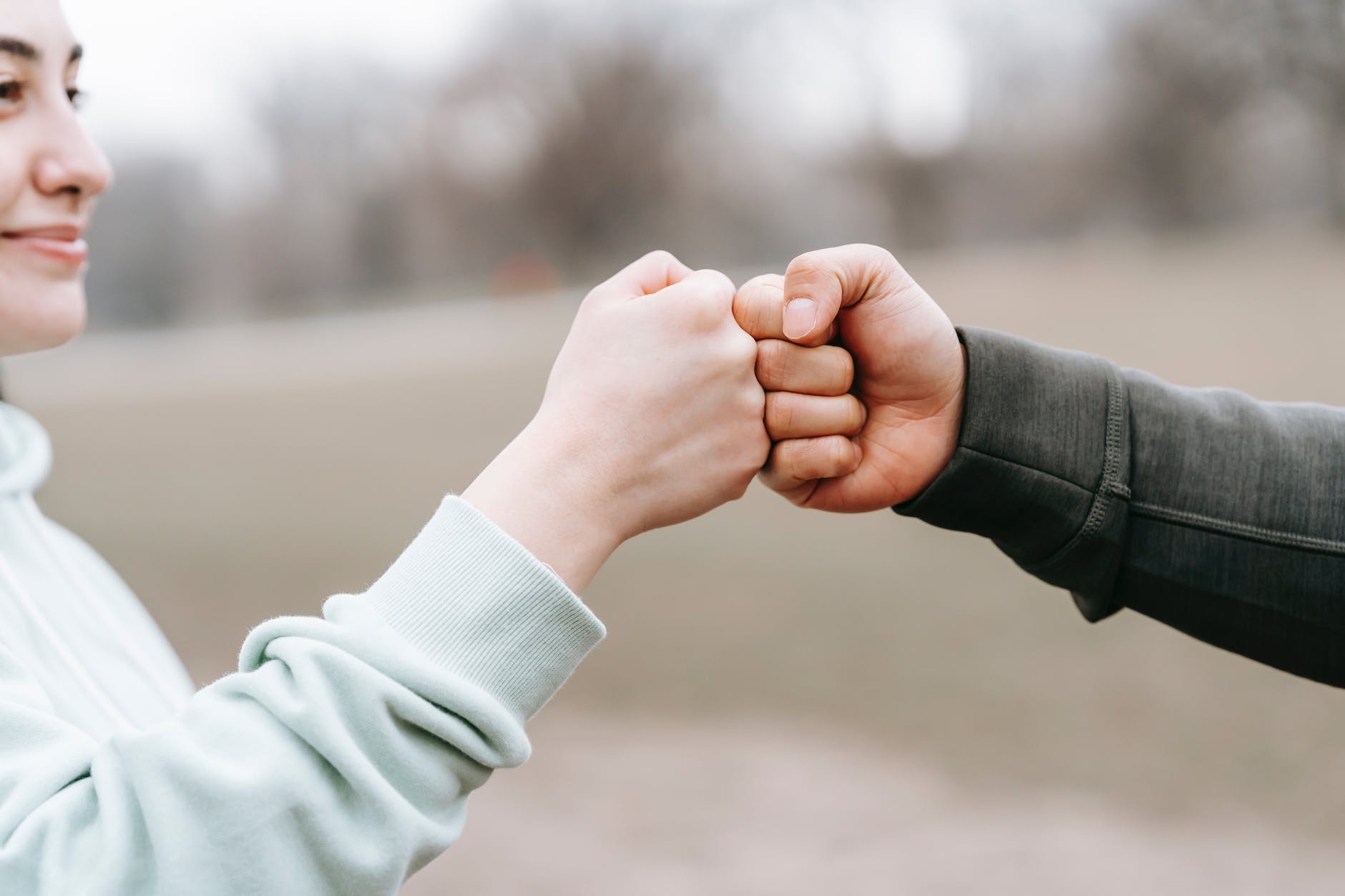 building partnerships man and happy woman greeting each other with fist bump